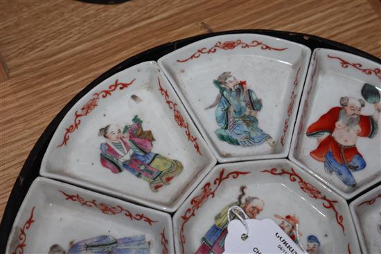 A 19th century Chinese famille rose immortals supper dish set, lacquer base only.